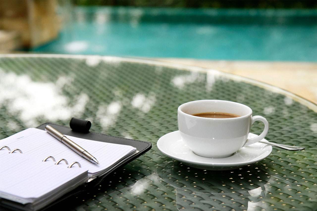 Do I need an accountant and bookkeeper? Coffee and notepad planning business image